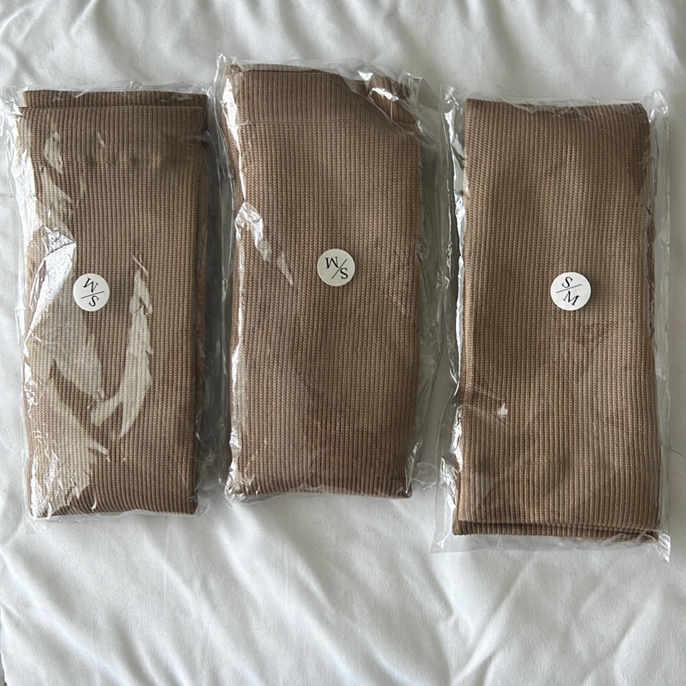 Three pairs of tan compression socks
